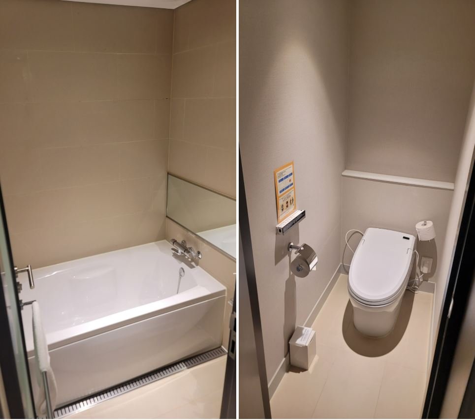 A modern and tidy room interior at Hotel Gracery Seoul showing the entry to the separated bathroom and toilet area.