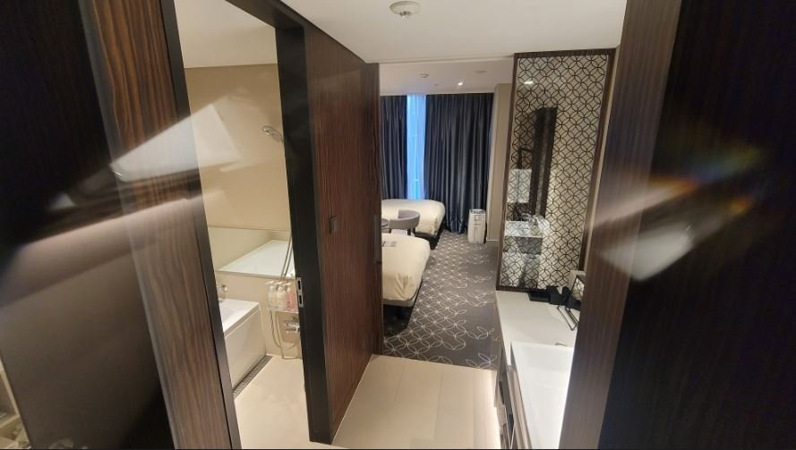 A close-up of the clean vanity sink area in Hotel Gracery Seoul with drawers storing amenities and towels below.
