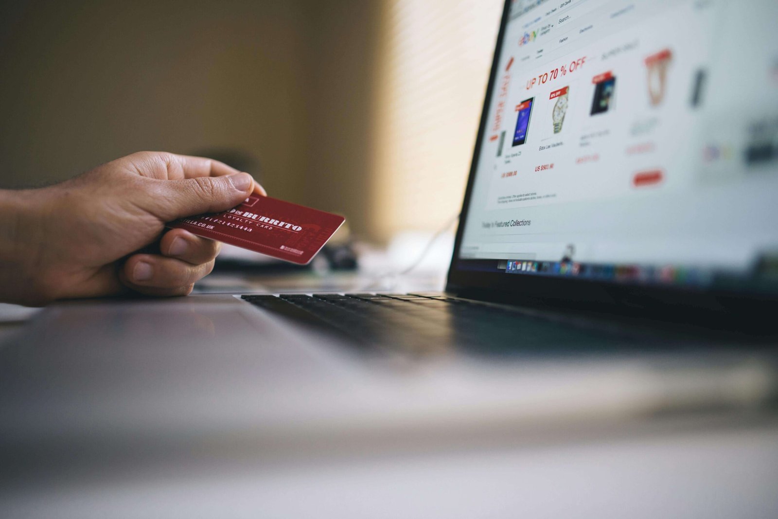 person holding a credit card while shopping online, illustrating how to stay alert against phishing and maintain safe credit card use in Korea