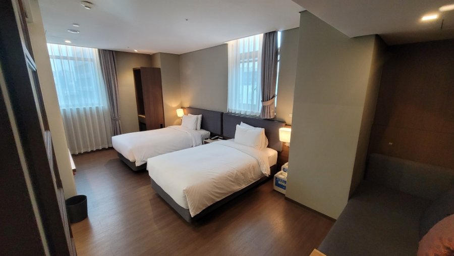 Comfortable and bright room interior with large windows, perfect for business or leisure travelers in this ENA Suite Hotel Namdaemun review.