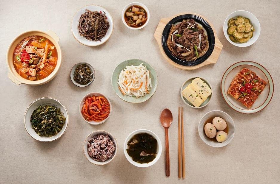 A vibrant spread of various Korean traditional food experience activities including kimchi making and tea ceremony