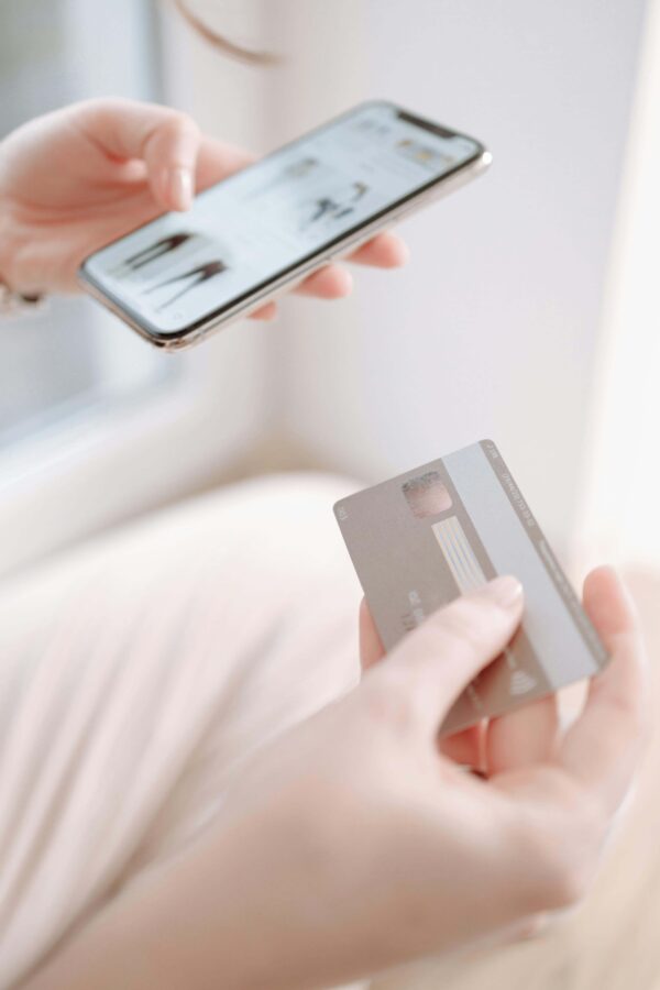 A close-up of a person using a mobile banking app to block a lost card, a crucial step for safe travel in Korea