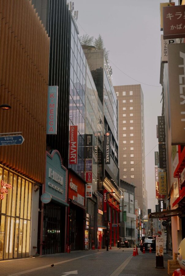A brightly lit, safe street in Seoul at night, showcasing the environment for safe travel in Korea